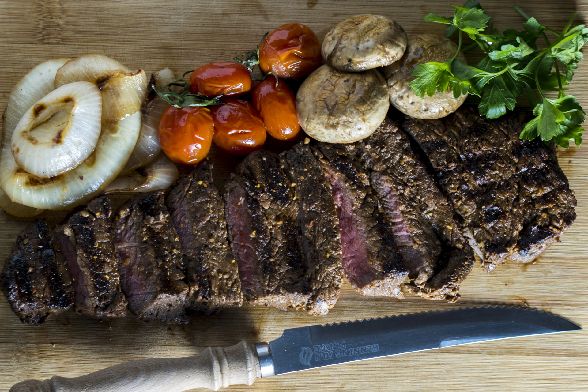 A beautifully plated grilled steak with a side of roasted vegetables, set on an elegant wooden table.