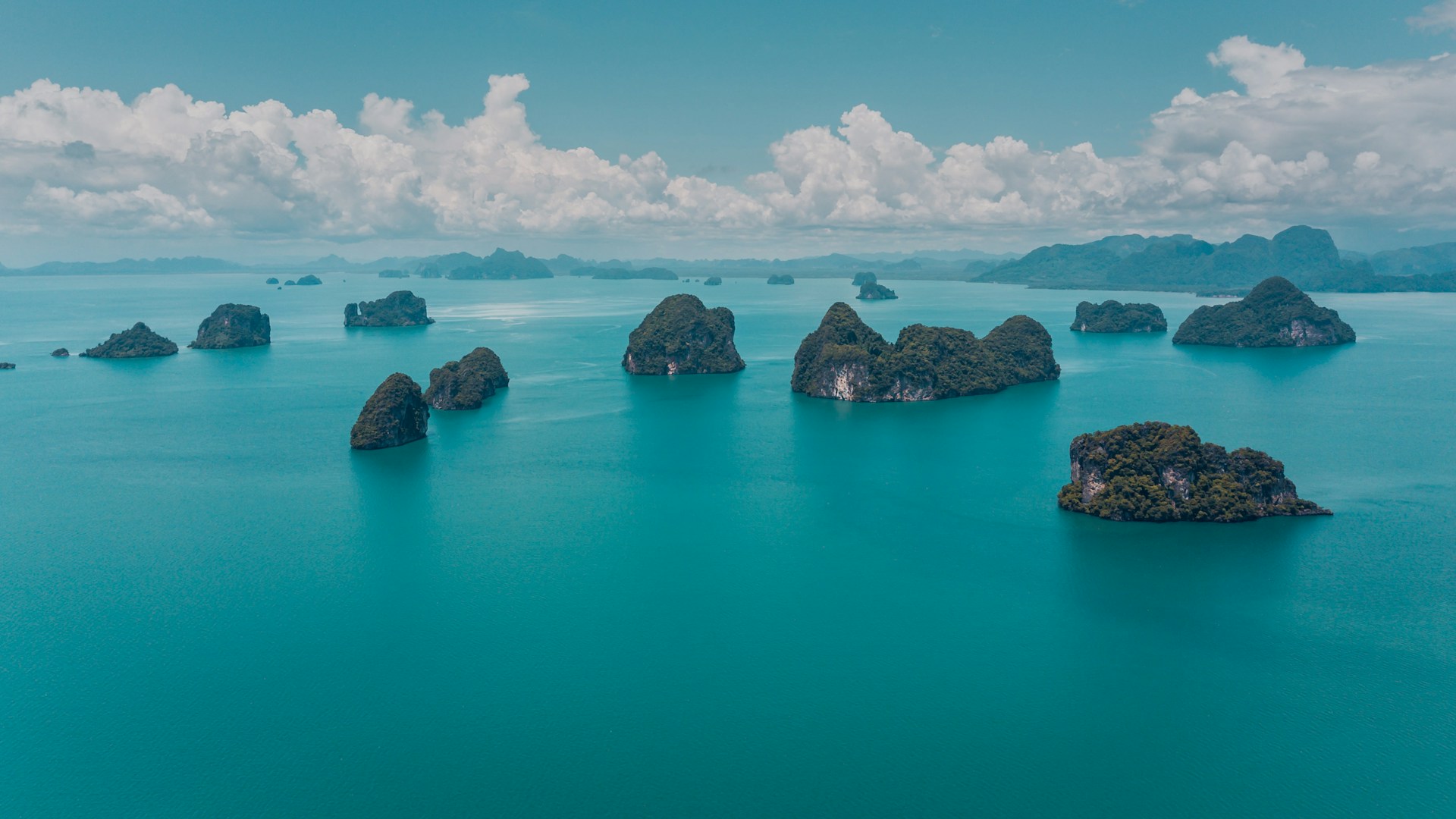 mountain surrounded by body of water during daytime