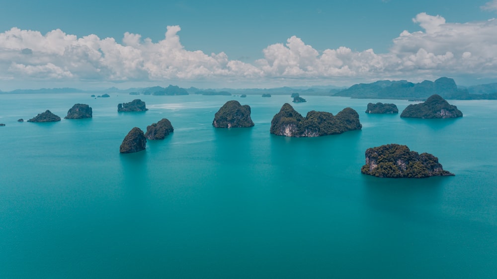 mountain surrounded by body of water during daytime