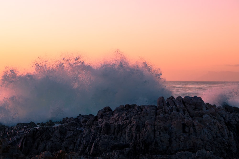 sea wave splashing on rocks