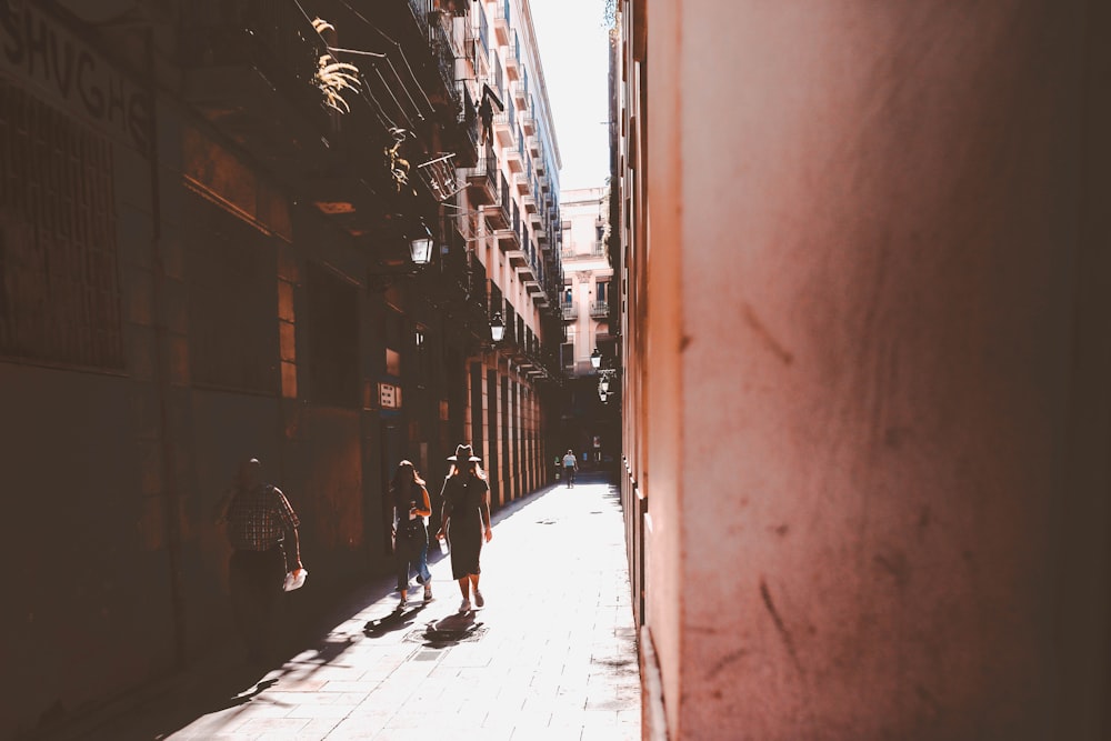 three woman walking beside building