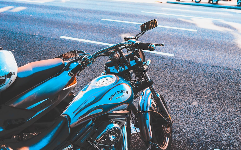 white and black motorcycle beside roads