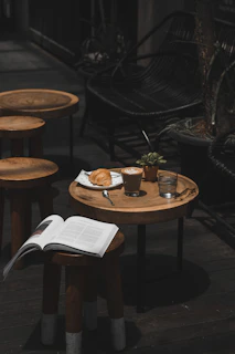 latte croissant and book on cafe table