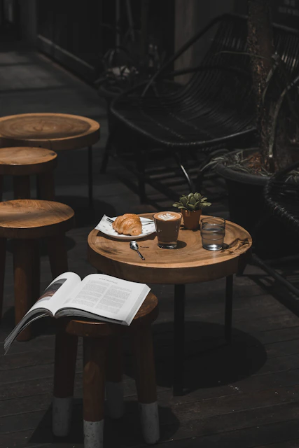 latte croissant and book on cafe table