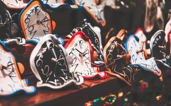 Melted clocks draped over fragmented, floating ruins in a dreamlike landscape.