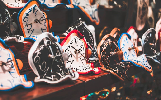 A detailed close-up of Salvador Dalí's intrauterine birth painting showing symbolic eggs and soft clocks.
