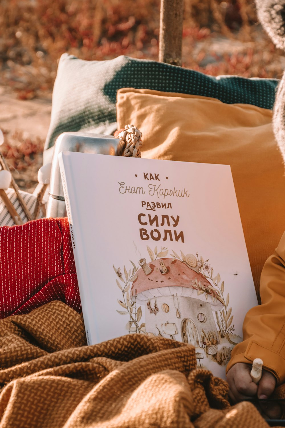 a person laying on a bed with a book