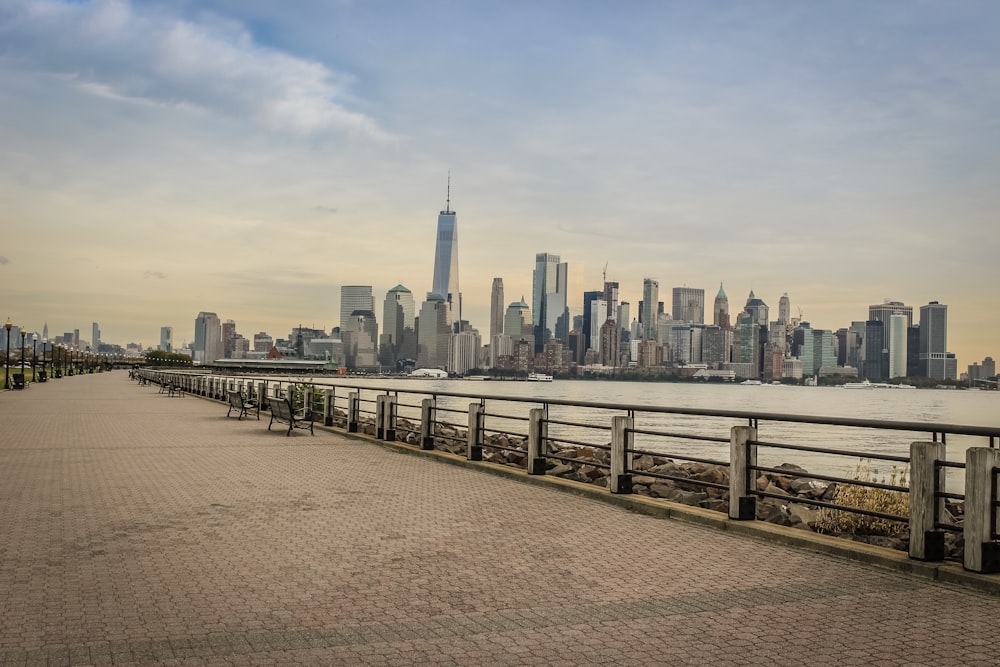 empty railings and benches overlooking buildings in skyline photography