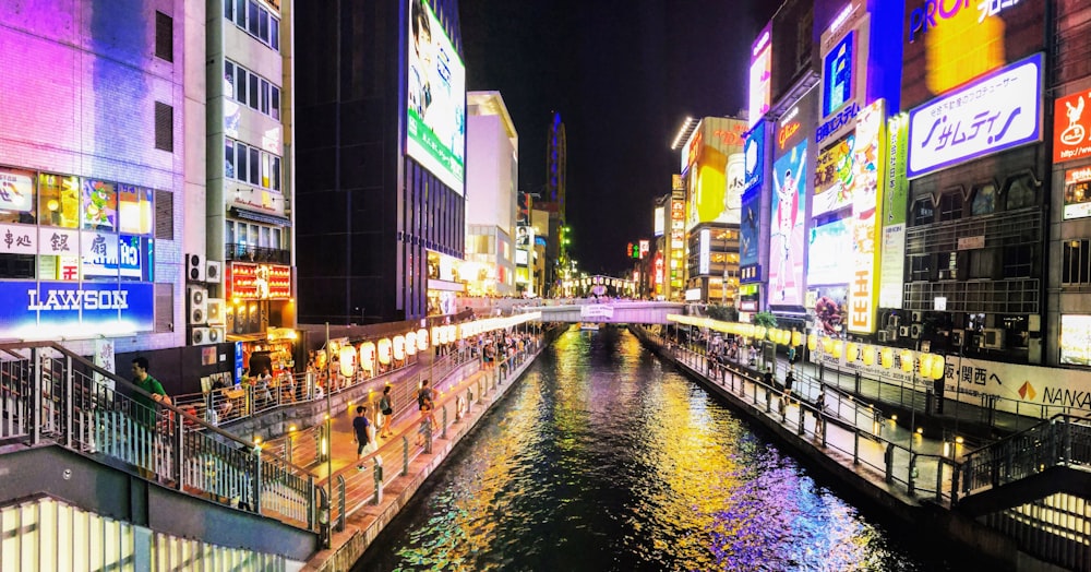 canal between lighted buildings at night