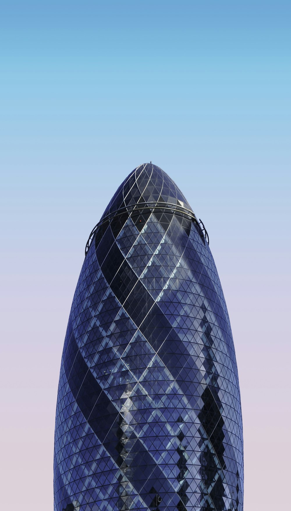 shallow focus photography of blue and black curtain wall building under blue sky at daytime