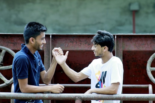 Two badminton players shaking hands after a friendly match outdoors