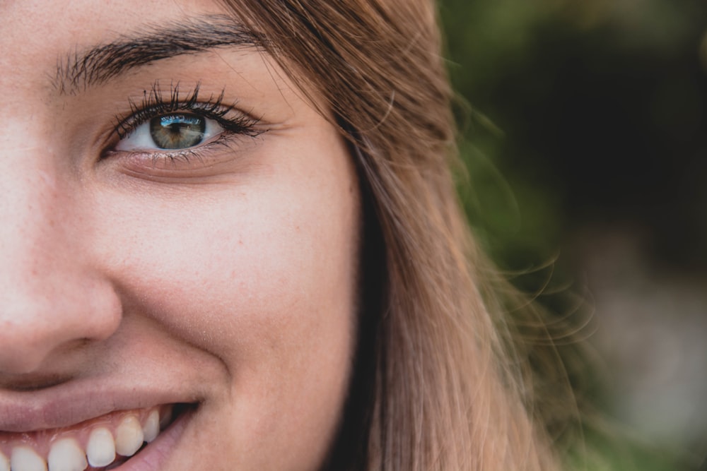 smiling woman with blonde hair in selective focus photography