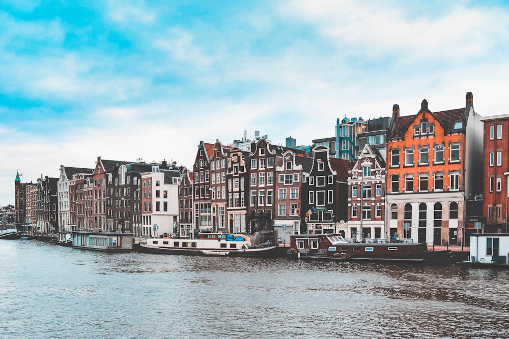 a group of buildings on the side of a river