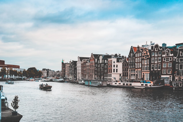 A scenic view of Amsterdam's iconic canals lined with traditional Dutch houses.