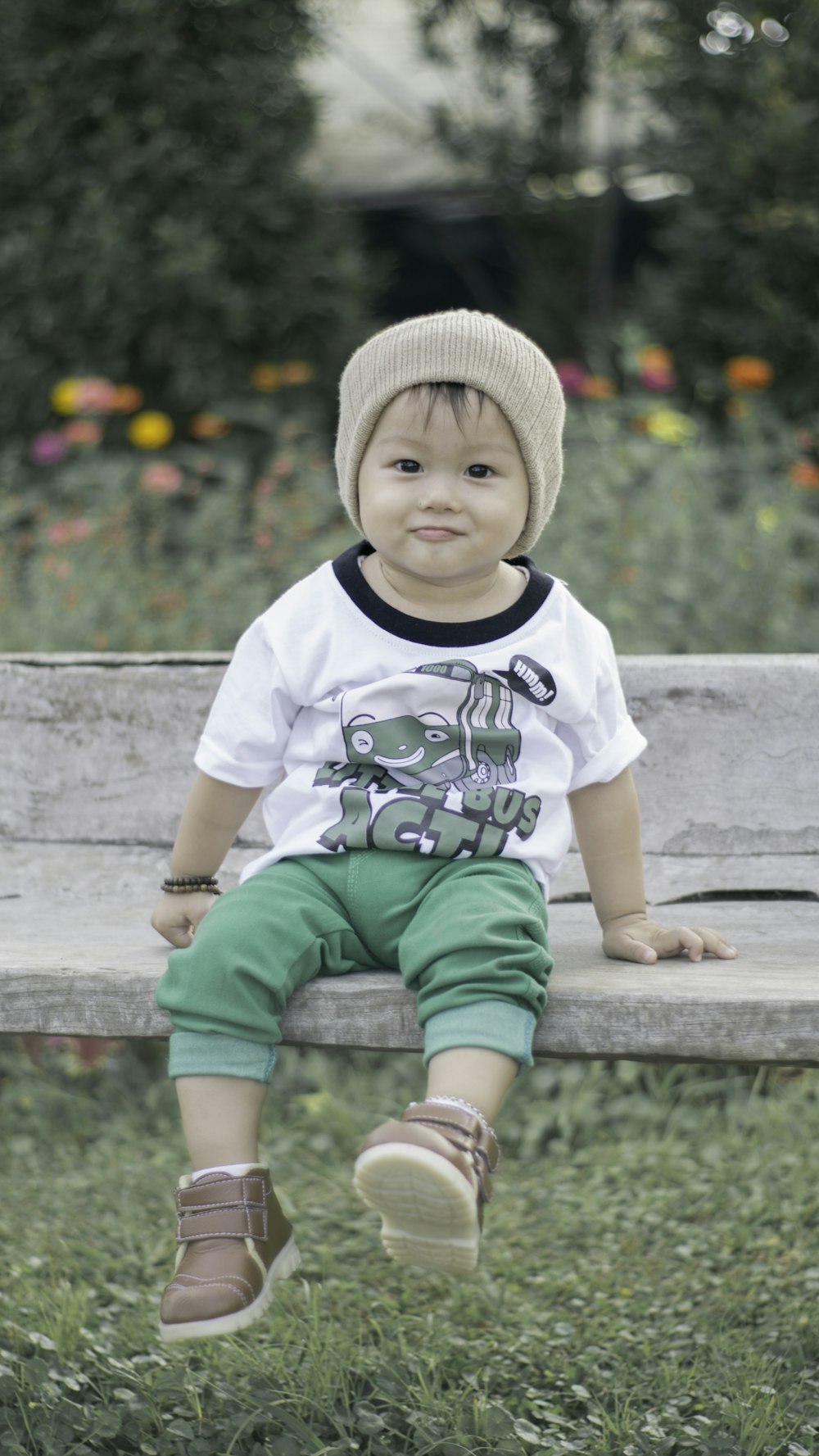 boy sitting on brown bench