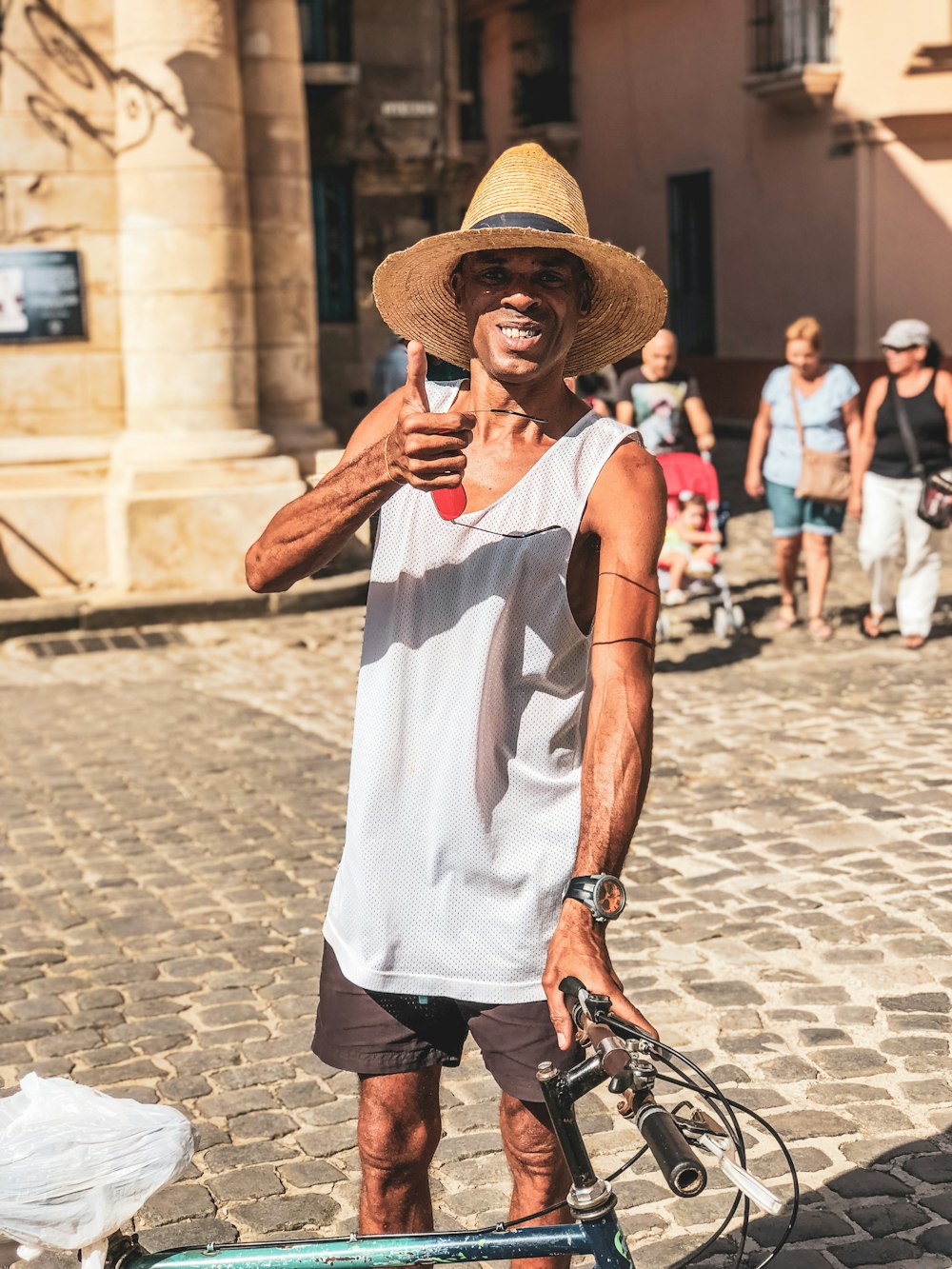 man holding bike doing thumbs up