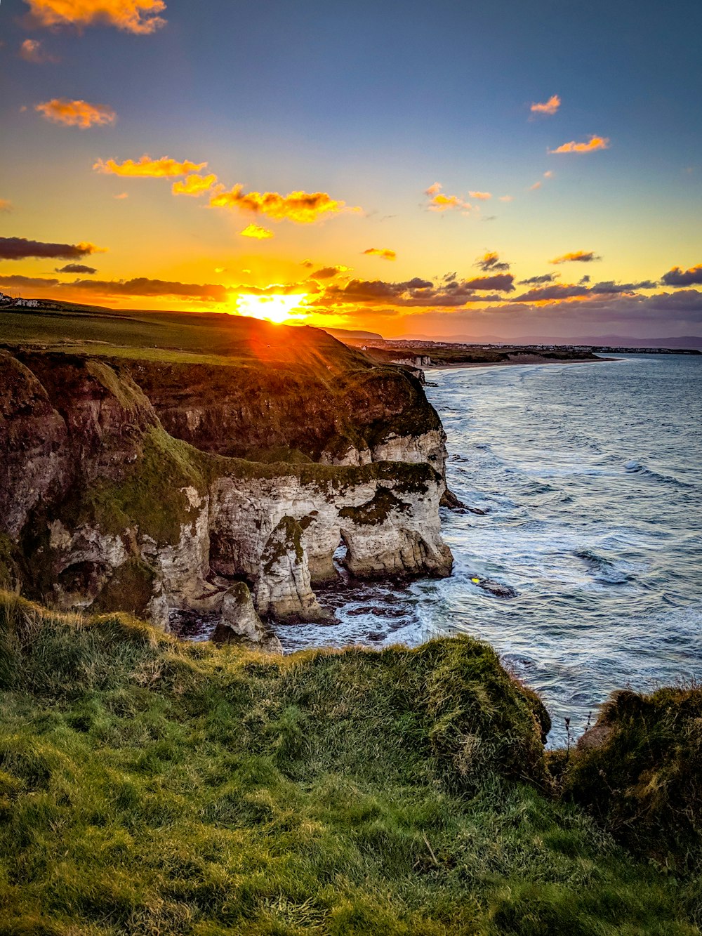 Klippe neben Gewässer bei Sonnenuntergang