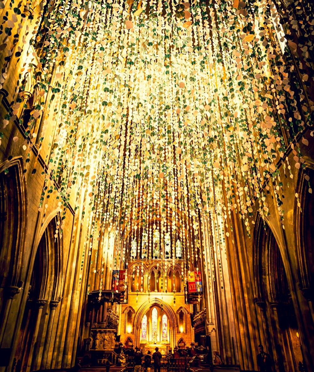 yellow string lights hangs from church ceiing