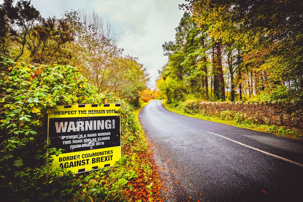 yellow and white warning road sign