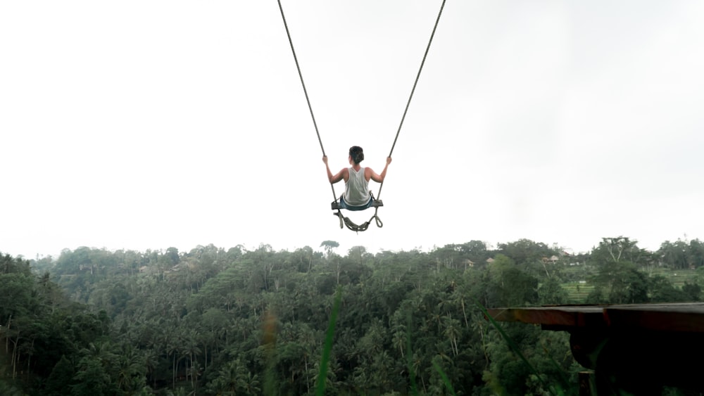 person riding on swing during daytime