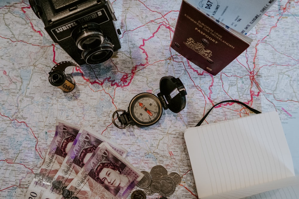 black pocket watch beside banknotes