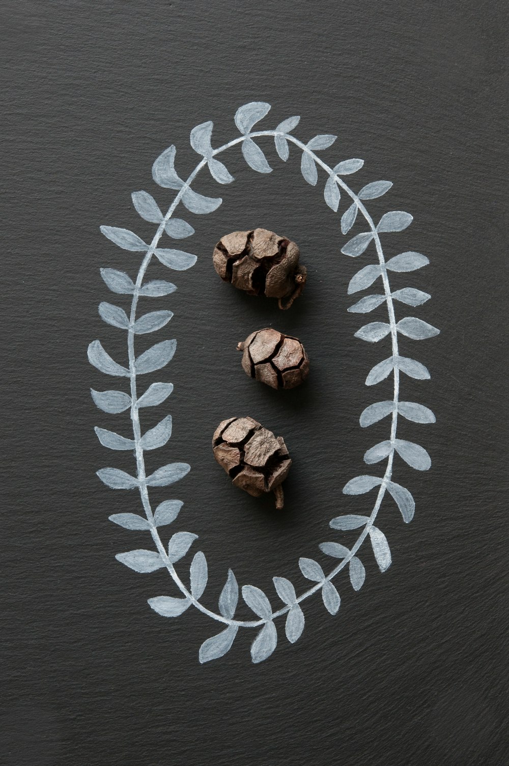 three brown fruits on gray textile