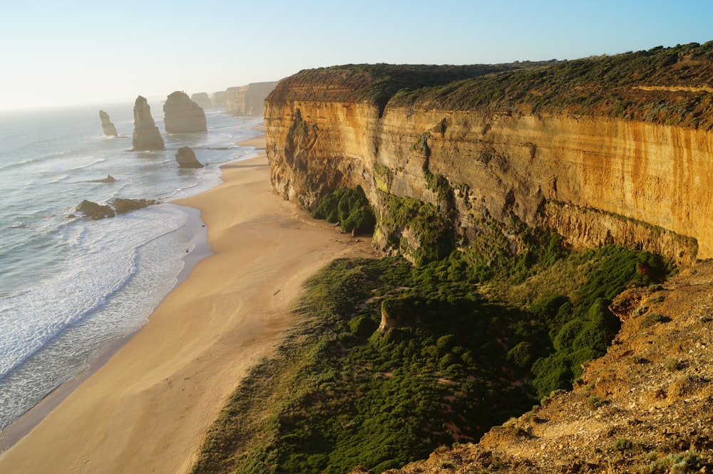 brown rock formation near sea