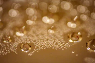 Close-up of golden liquid droplets suspended mid-air, shimmering like liquid gold against a deep charcoal backdrop.