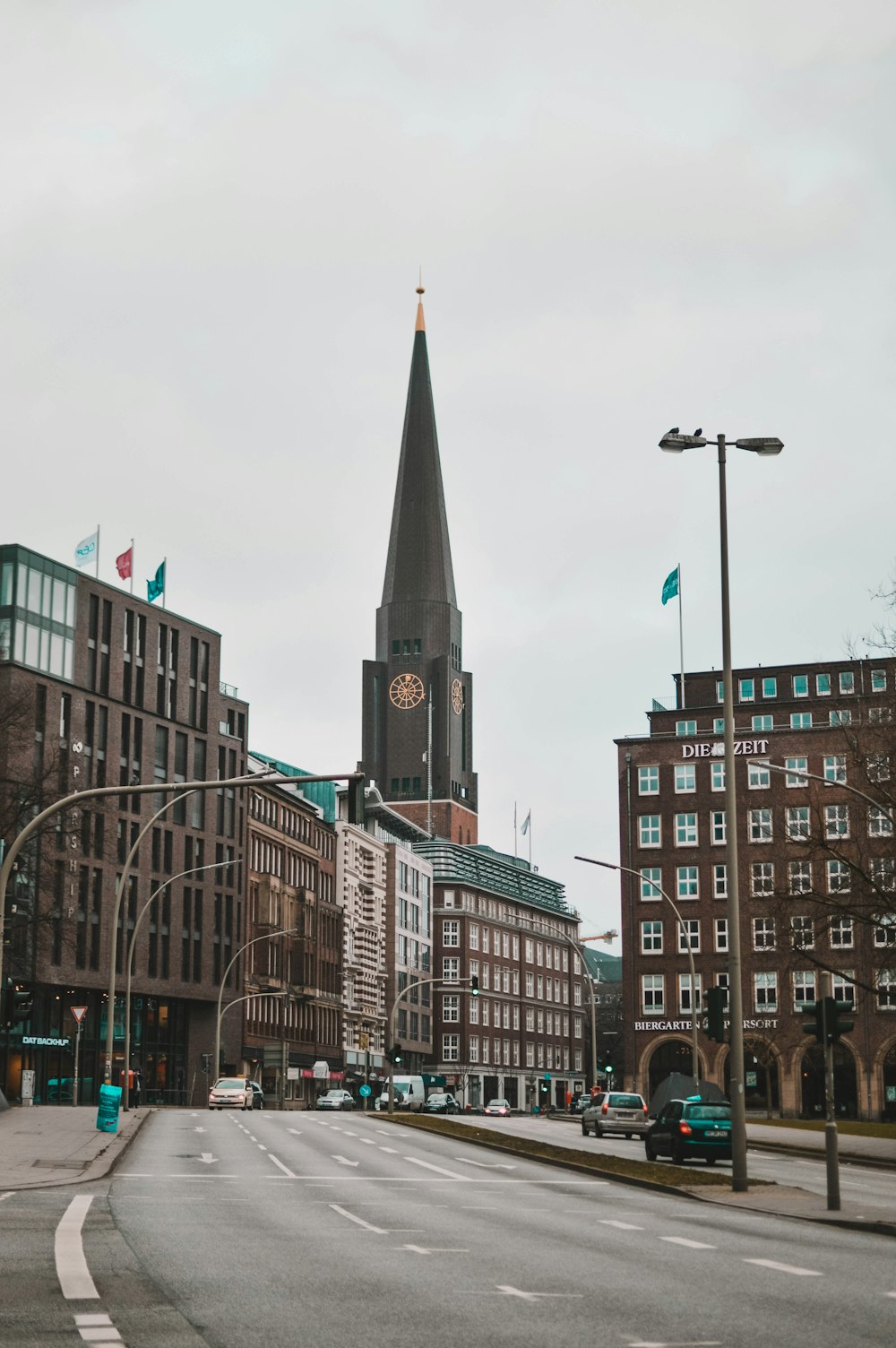 tower clock beside road during daytime