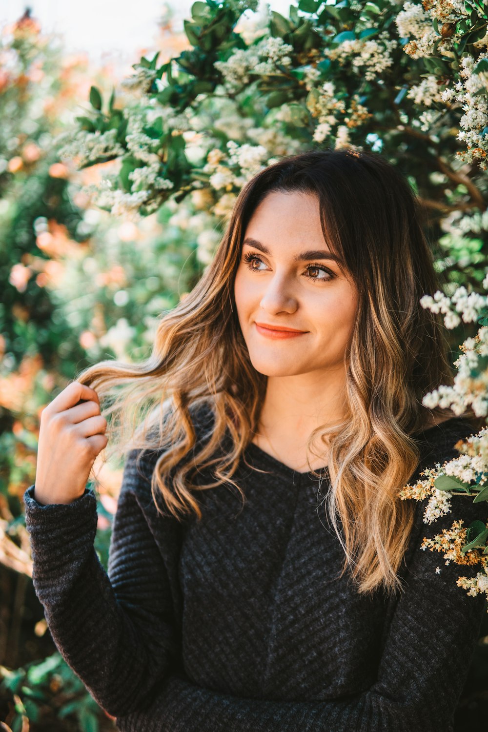 smiling woman in black long sleeved shirt