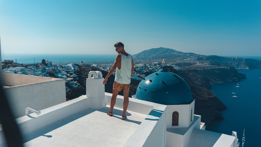man standing on top of Santorini Greece