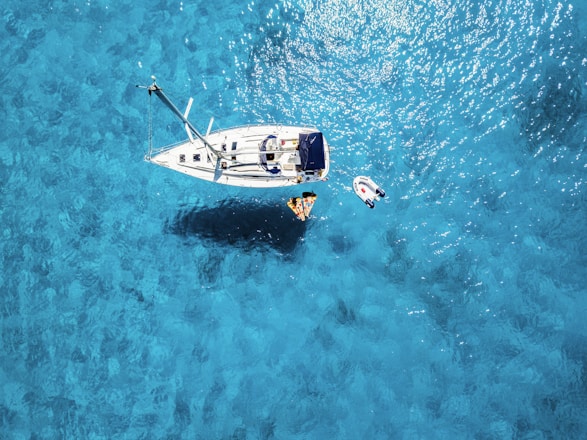 white yacht in middle of blue sea