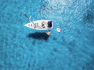 white yacht in middle of blue sea