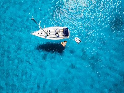 white yacht in middle of blue sea