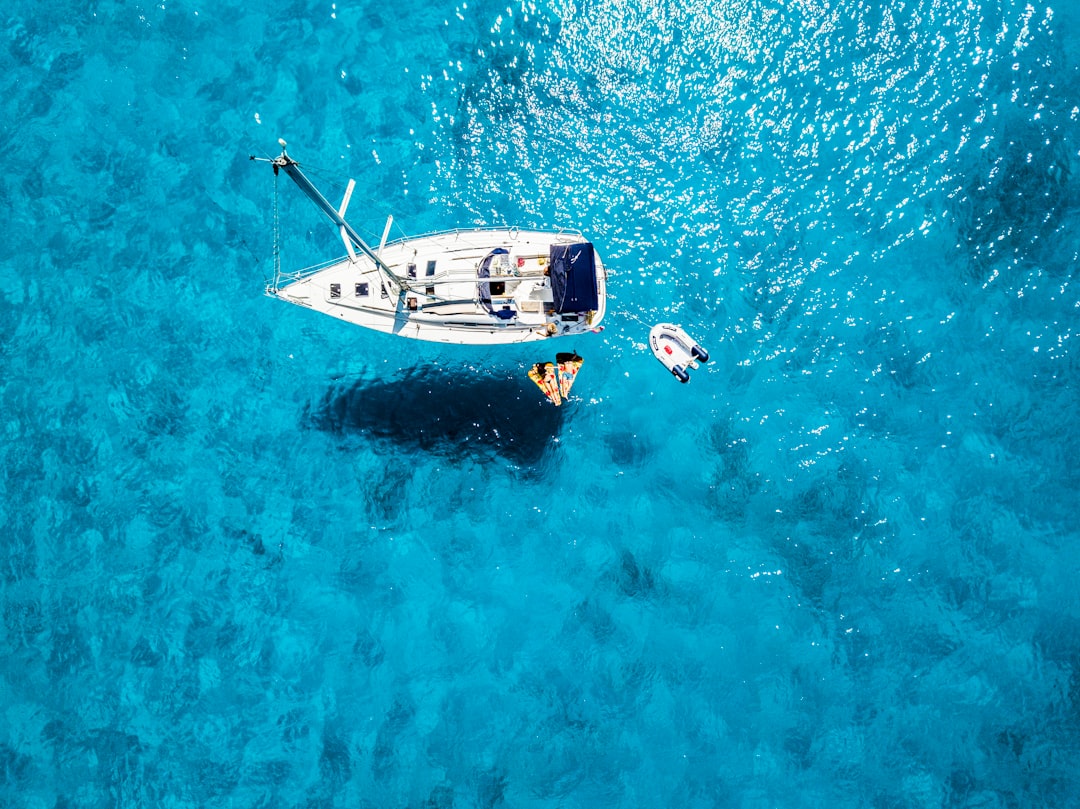 white yacht in middle of blue sea