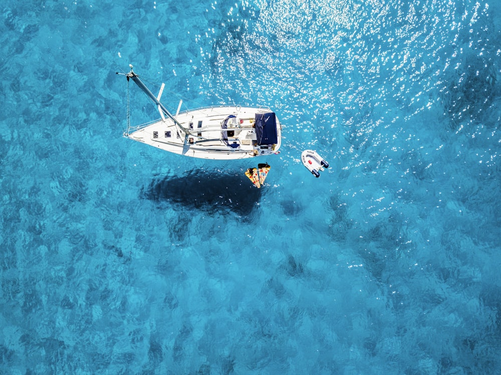 white yacht in middle of blue sea