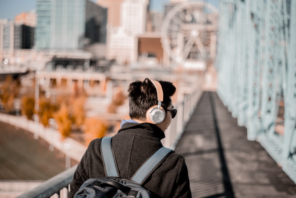 man wearing brown cordless headphones