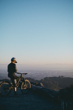 A beginner triathlete preparing their bike gear outdoors at sunrise