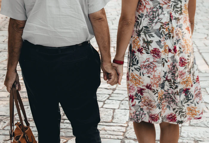 An older couple holding hands