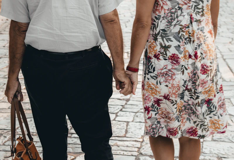 An older couple holding hands