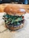 A delicious burger with fresh ingredients on a wooden table.