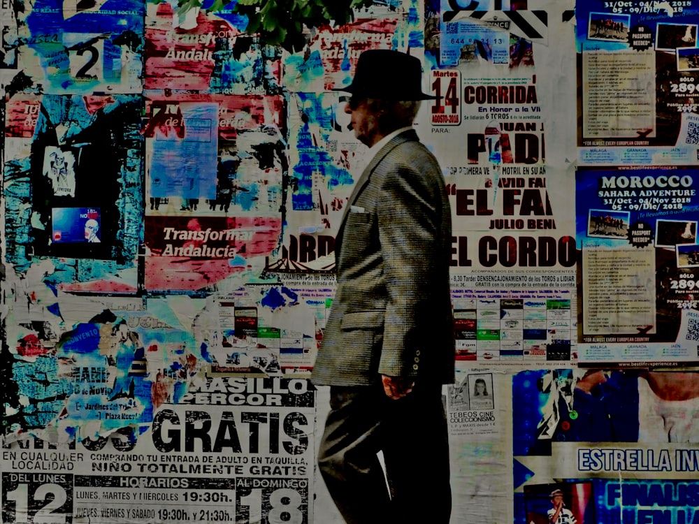 man standing beside painted wall