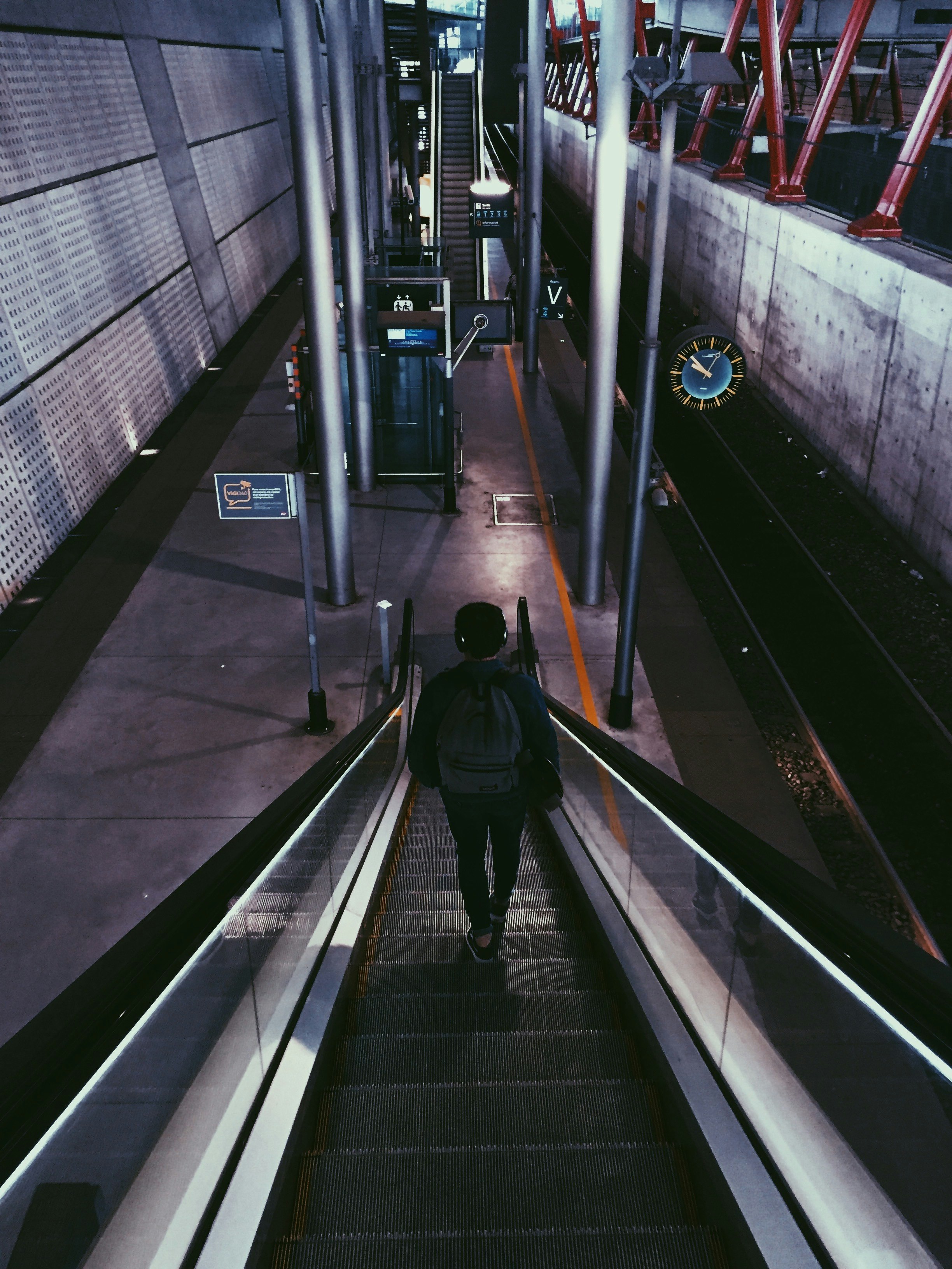 man standing on escalator