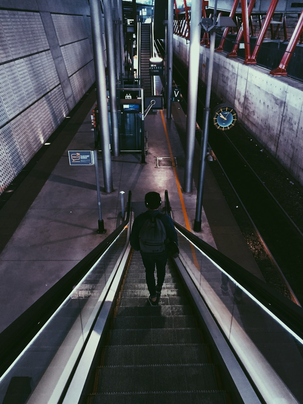 man standing on escalator