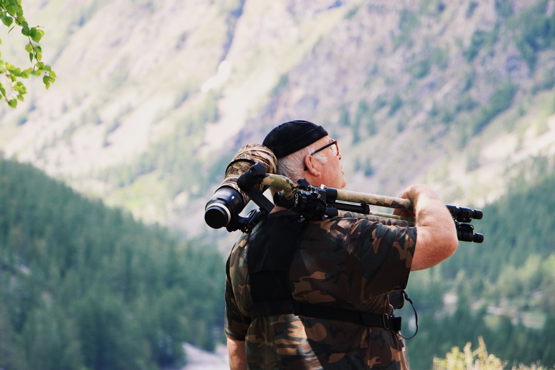 man carrying tripod