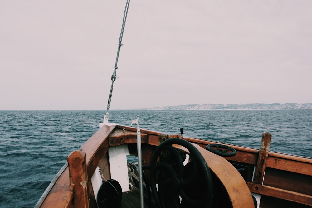 brown boat on body of water during day time