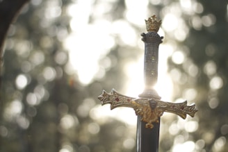 close-up photography of gold-colored and black sword