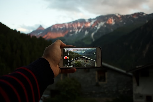 person taking picture of house