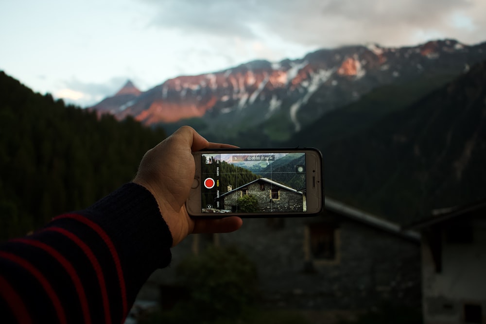 person taking picture of house