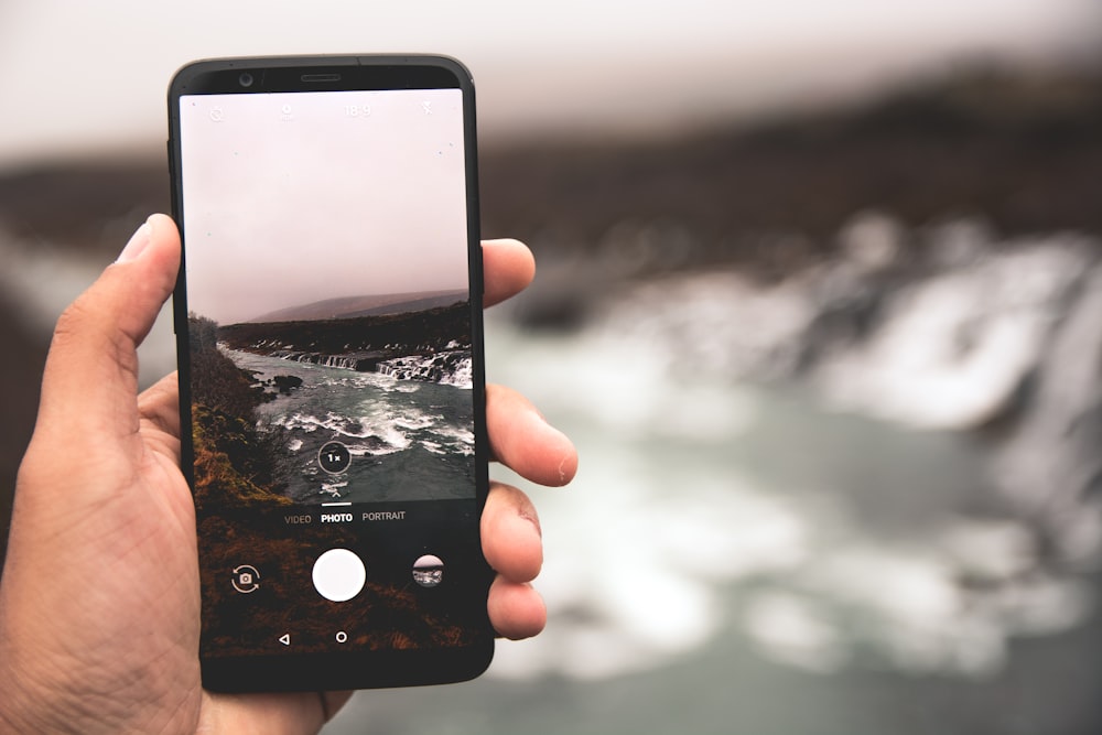 person holding black Android smartphone